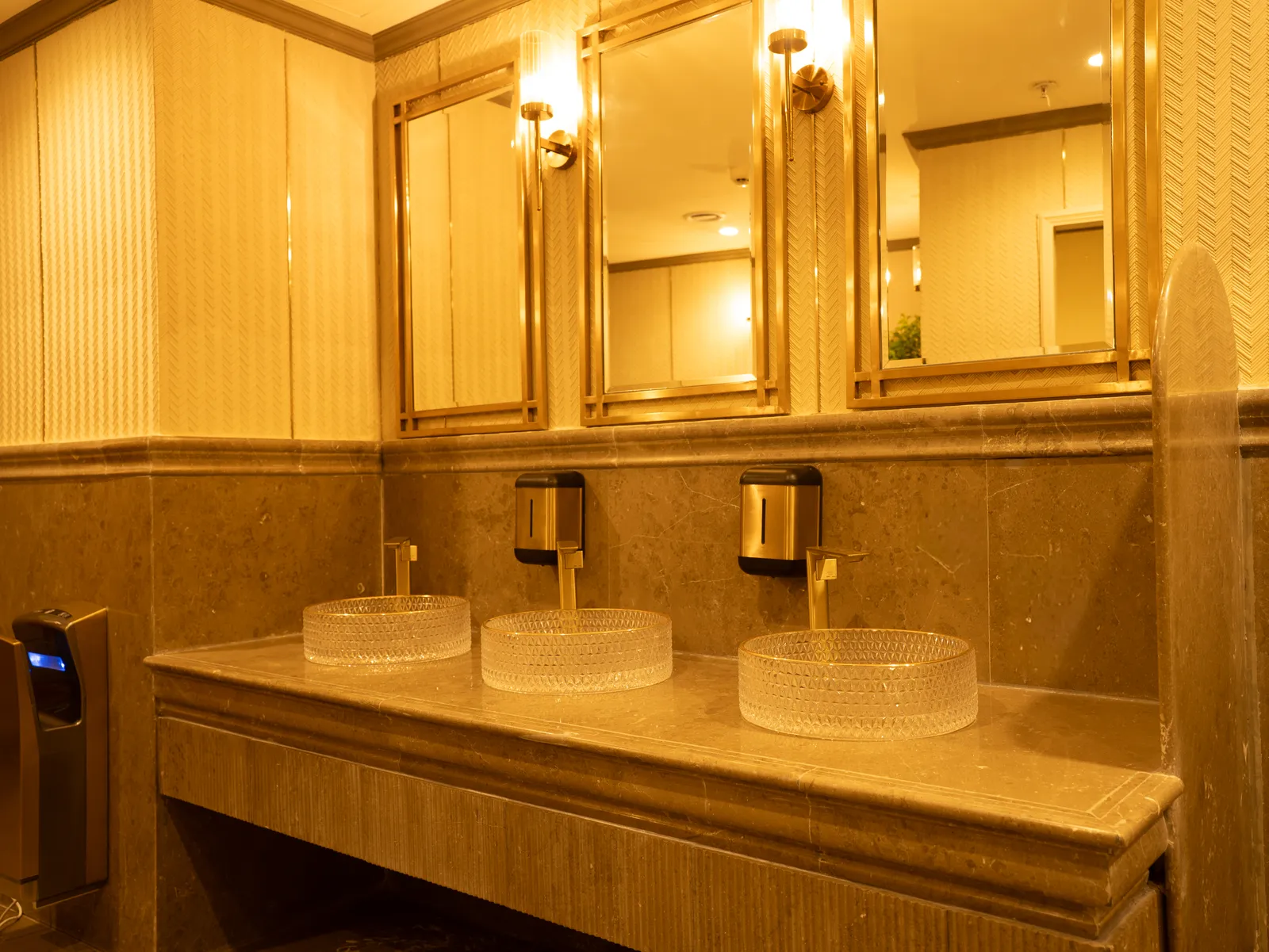 Vanity counter with glass vessel basins and brass mirrors — Chalukya Samrat